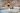 Artificial,Peonies,Flowers,In,White,Ceramic,Vase,On,White,Table.